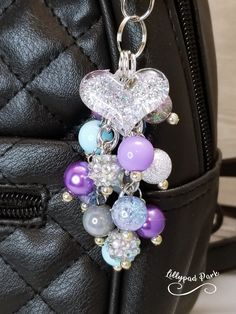 a black purse with some charms attached to it