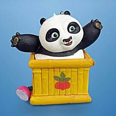 a toy panda bear sitting in a yellow box with its arms out and eyes wide open