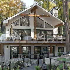 a large house in the woods with lots of windows and balconies on it