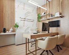 a desk with two chairs and a computer on it in front of a wooden wall