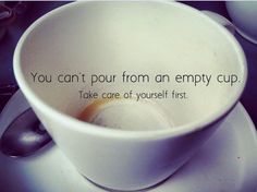 a white cup with a spoon in it on top of a plate that says, you can't pour from an empty cup take care of yourself first