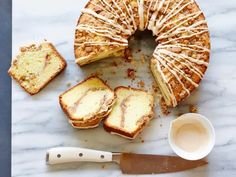 a marble table topped with sliced cake next to a knife