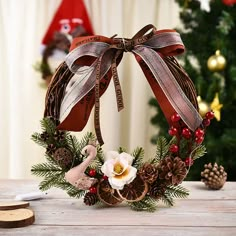 a christmas wreath with pine cones and flowers