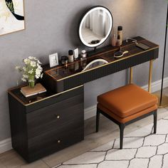 a dressing table with a mirror and stool in front of it, next to a plant