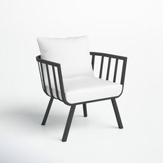 a black and white chair with a white pillow on it's backrest, sitting in front of a white wall