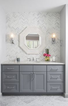 a bathroom with two sinks and a mirror on the wall above it's counter