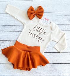 "Thanksgiving Outfit Girl, Little Turkey Fall Outfit, Baby Girl First Thanksgiving Outfit, Niece Aunt Gift You may choose: ~\"Little Turkey\" bodysuit as shown. Available in short or long sleeve. ~Adorable skirted bummie/bloomer created in the perfect fall color. ~Matching fabric bow/headband All items are handmade in our studio with loving care. Copyright © 2008 by ChristiCreations®, LLC. All rights reserved. This design or any portion thereof may not be reproduced or used in any manner whatsoe Infant Thanksgiving Outfit, Thanksgiving First Birthday Girl, Thanksgiving Onesie Girl, Fall Newborn Outfits, Newborn Fall Outfits, First Thanksgiving Outfit Girl, Newborn Thanksgiving Outfit, Baby First Thanksgiving