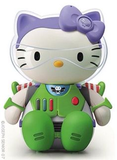 a hello kitty toy sitting on top of a white floor next to a green and purple teddy bear