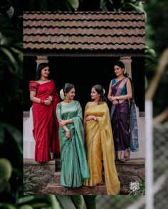 three women in sari standing next to each other