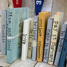 a row of books sitting on top of a wooden table next to each other in different colors