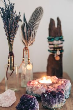 a table topped with rocks and candles on top of it