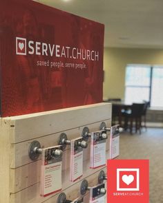 there is a sign that says serve at church on the wall in front of it