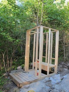 a wooden structure sitting on top of a pile of rocks