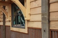 an arched window on the side of a wooden building