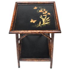 a small wooden table with flowers painted on it