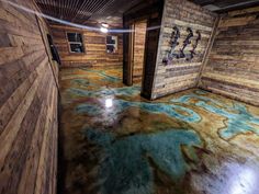 a room with wooden walls and flooring that looks like it has been dyed blue