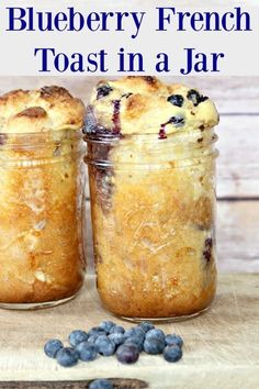 two jars filled with blueberry french toast in a jar next to fresh blueberries