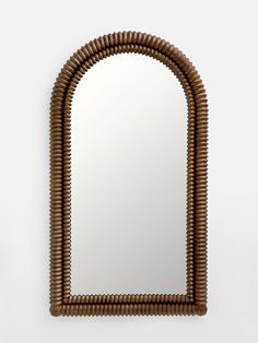 a mirror that is made out of wood and has a wavy design on the frame