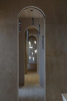 an archway leading into a room with lights hanging from the ceiling