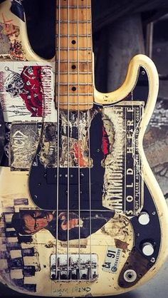 an old bass guitar with some stickers on it