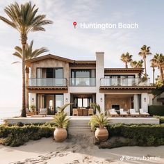 a large house on the beach with palm trees