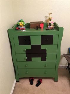 a green dresser with some toys on top of it