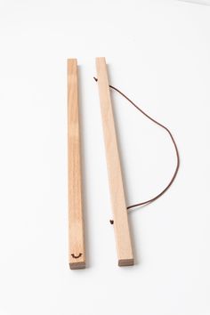 two pieces of wood with string attached to them