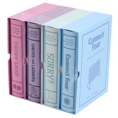 three different colored books in a box