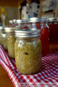 four jars filled with food sitting on top of a red and white checkered table cloth