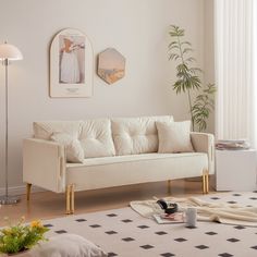 a living room with a white couch and black and white checkered rug on the floor