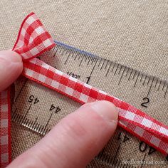 a person is measuring their length with a tape measure on the side of a piece of fabric