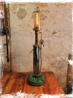 an old fashioned lamp sitting on top of a wooden table