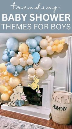 winnie the pooh baby shower theme with balloons and other items in front of it