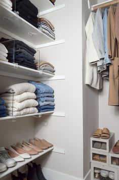 an organized closet with white shelves and shoes