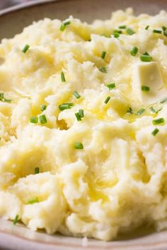 mashed potatoes with chives in a white bowl