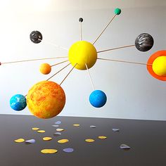 the solar system is made up of different colored balls and dots on a gray surface