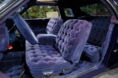 the interior of a car with blue velvet upholstered seats