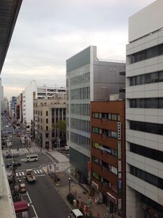 a city street filled with lots of traffic and tall buildings next to eachother