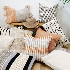 a pile of pillows sitting on top of a wooden table