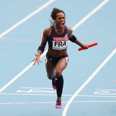 a woman running on a race track