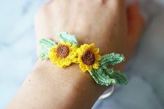 handmade micro crochet sunflower bangle 14K gold plated adjustable bangle with a miniature crochet flower.  These bangles are made with a DMC cordonnet. They are lightweight and perfect for all-day wear. bangle is gold-plated brass from Korea. If you have any questions, please reach out to us via messages before purchasing. *All items are handmade and may contain minor imperfections & and a little color difference and variation between the picture and the actual item. But it doesn't make a big difference overall. Since this is a handmade item, we recommend handling these pieces with care. Do not bend or set heavy items on top of the bangle.  ORDER  This item is made to order. Once the order is placed, I need 7 business days to prepare and ship the item. thank you! Dainty Handmade Yellow Bracelets, Adjustable Bracelets For Summer Weddings, Spring Bangle Jewelry Gift, Spring Gift Bangle Jewelry, Bohemian Crochet Bracelets As Gift, Summer Flower Shaped Jewelry Gift, Adjustable Crochet Jewelry Bracelet, Resizable Jewelry As A Spring Gift, Resizable Jewelry Gift For Spring