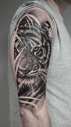 a man with a tiger tattoo on his arm