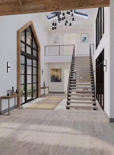 an open floor plan with stairs leading up to the second floor and windows on both sides