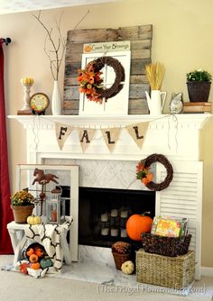 the fireplace is decorated for fall with pumpkins and other things to decorate on it