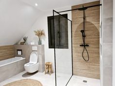 a bathroom with a toilet, shower and bathtub in the middle of the room