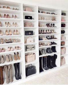 a white closet filled with lots of different types of shoes and purses on shelves