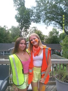 two women in safety vests standing on a deck