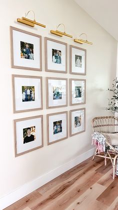 a living room with pictures on the wall and a wicker chair next to it