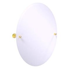 an oval white object with two gold studs on the top and one yellow bead at the bottom