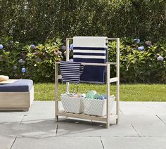 a blue and white chair sitting on top of a patio next to a table with two baskets